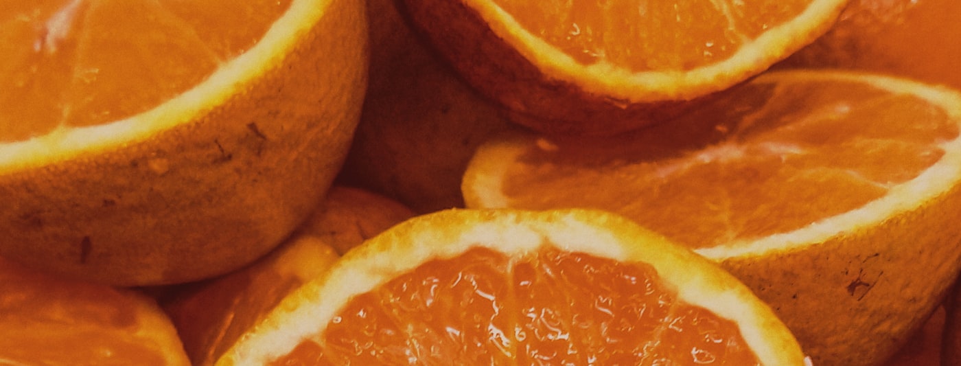 Sliced orange fruit on a wooden table