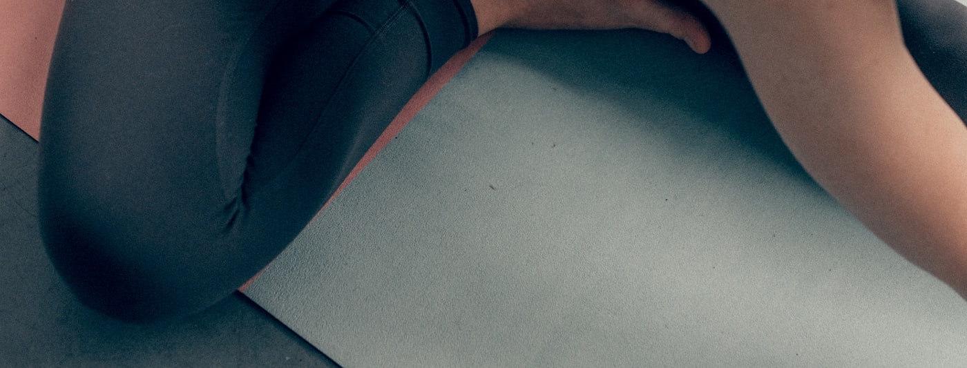 A person stretching on an exercise mat