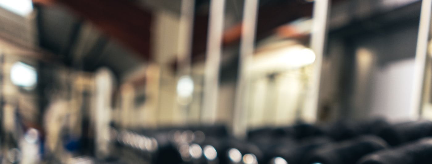 A row of dumbbells on a gym rack